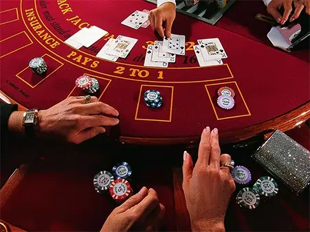 hands playing at blackjack table