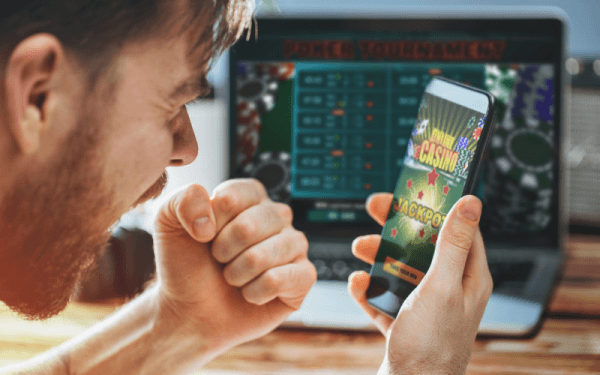 man playing at an online casino on his phone